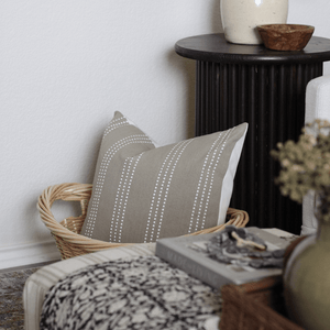 A close up of the Darcy pillow from Colin + Finn inside a basket