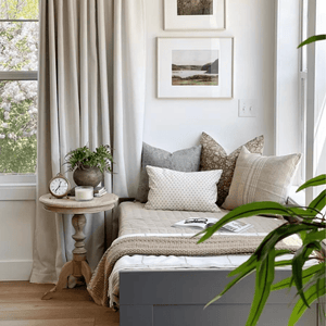 A daybed in the corner of a room with Eloise, Eleanor Natural, Kinsey, and Elodie Lumbar pillows