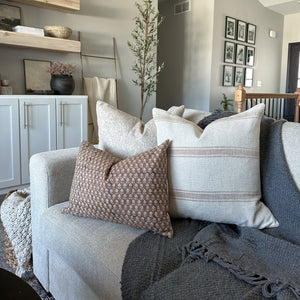 Arizona, Louise, and Emery lumbar pillow covers from Colin and Finn on gray sofa with gray blanket on sofa.