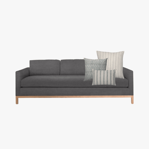 Dark gray sofa mockup of Ava pillow combination.