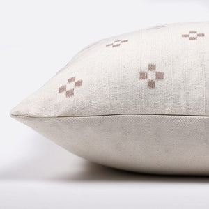 Side view of Dara pillow cover showing invisible zipper, rust crosses on ivory front, and solid ivory back.