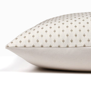 Side view of Colin and Finn's Elodie lumbar pillow cover showing the solid ivory backing and the ivory/taupe embroidered front design.