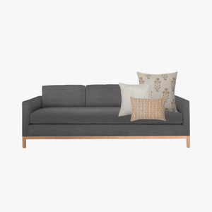 Felicity pillow combo on dark gray couch.