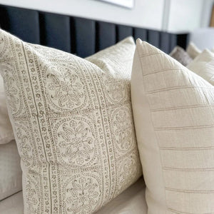 Close up of Karina and Logan pillow covers from Colin and Finn showing detailed fronts and solid ivory backing.