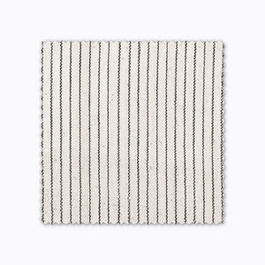 Laney fabric swatch from Colin and Finn. A charcoal stripe on handwoven ivory linen.