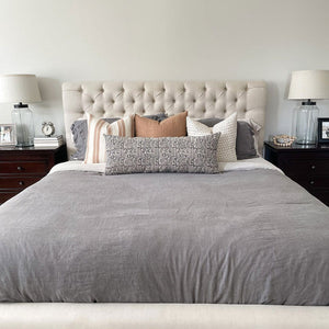 Liam, Sutton, Luella, and Madison long lumbar from Colin and Finn on bed with gray comforter and white upholstered headboard.