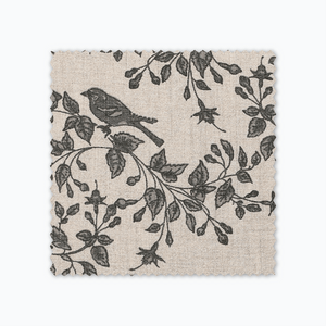 Magnolia fabric swatch from Colin and Finn. Green florals and birds on a cream background