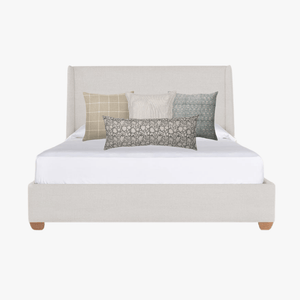Malibu pillow combination mockup on white headboarded bed.