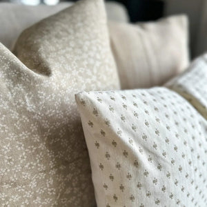 Close up of Elodie and Neville in Sand pillow covers from Colin and Finn showing the taupe embroidery details.