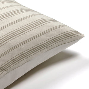 Corner of Oscar pillow cover from Colin and Finn on a white background showing the stripes and solid ivory backing.
