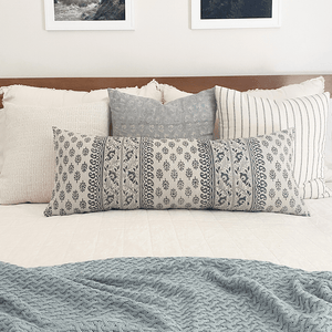 Rowan pillow combination showing Selma, Eloise, Winston, and Jasmine oversized lumbar on white bed with wood headboard.