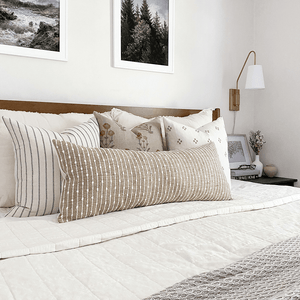 Savanna pillow combination on white bed with taupe throw.