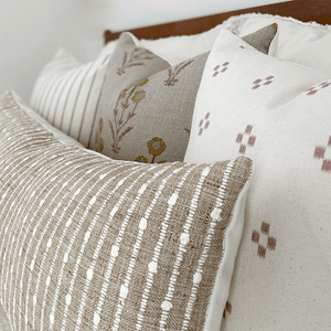Close-up of Savanna Combination showing rust, cross details of Dara pillow cover.