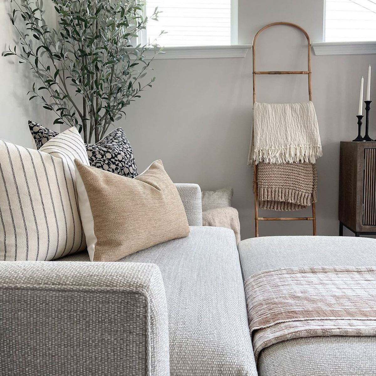 Edina, Winston, and Mason lumbar pillow covers on gray oversized chair.