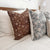 Closeup view of Agnes and Lenora pillows from Colin and Finn, showing their floral pattern on the front and solid, ivory backing.