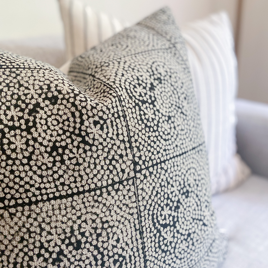 Closeup view of Anderson pillow cover with blurred out Winston pillow cover in the background.