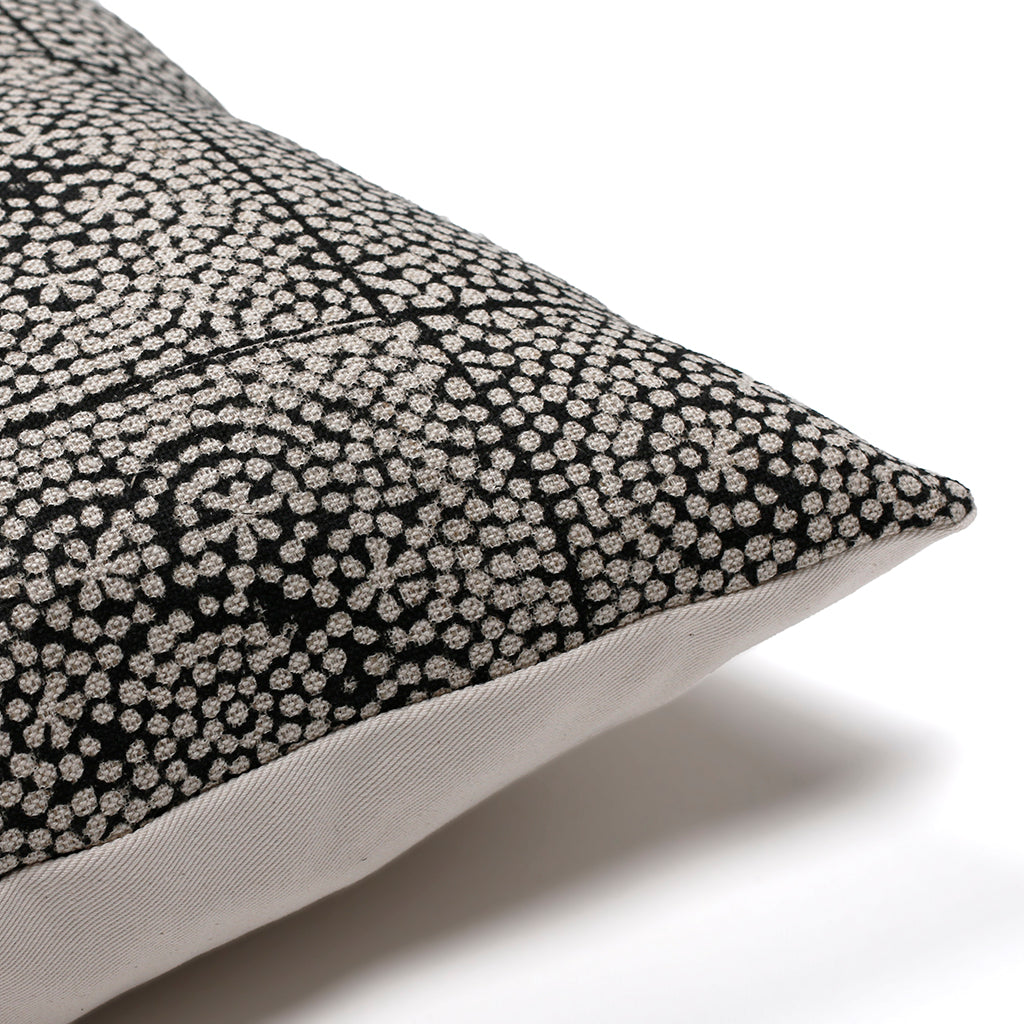 Upper corner of Anderson pillow cover from Colin and Finn with white background and showing natural ivory backing.
