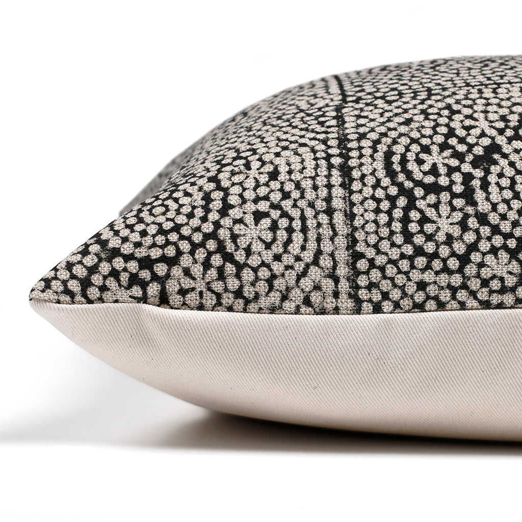 Side view of Anderson pillow cover showing the invisible zipper separating the black and flax linen front and solid ivory backing.
