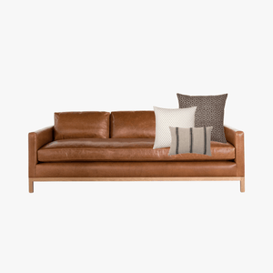 Aurora Pillow Combo with Neville Mocha, Elodie, and Maverick Lumbar on a leather sofa