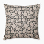 A square decorative pillow with an intricate floral pattern. The design features beige flowers and leaves on a dark background, creating an elegant and detailed texture. Callum Pillow Cover's edges are clean and simple, enhancing its refined appearance.