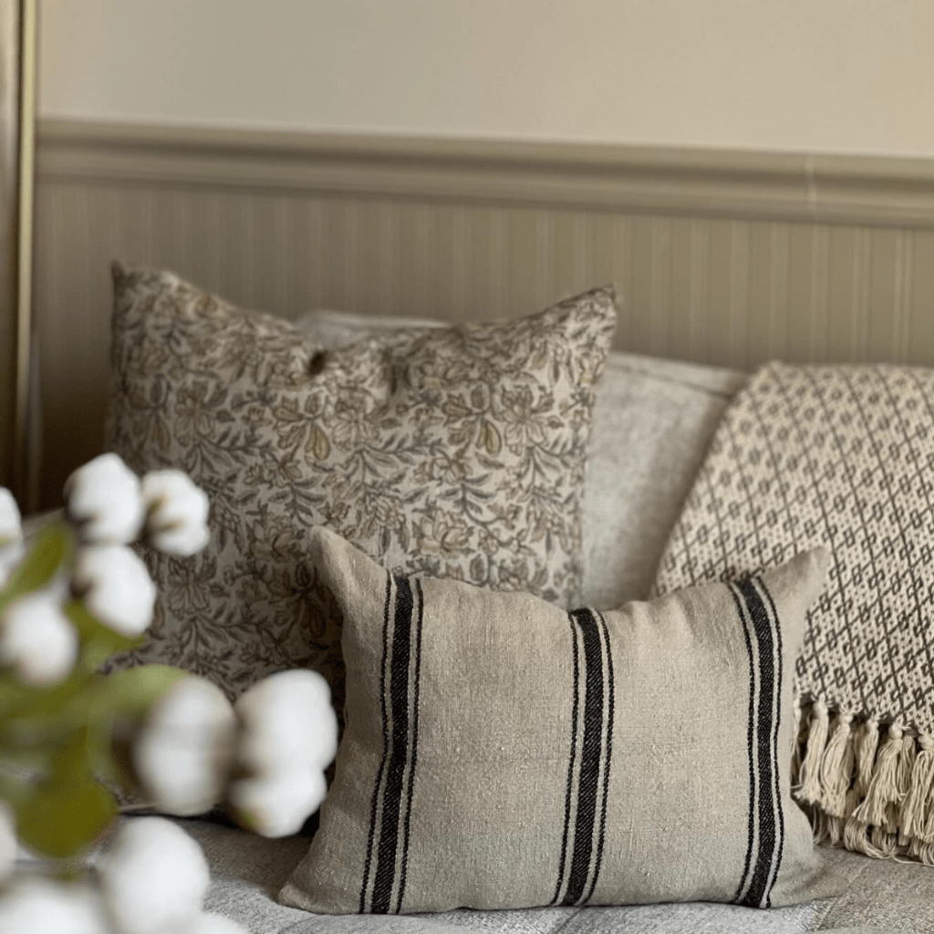 Elain and Maverick Lumbar on a grey sofa