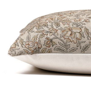 Side view of the Elain pillow cover from Colin and Finn showing the block printed floral front with beige, taupe, and green on a linen textile and an ivory backing.