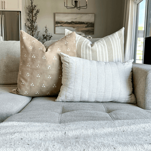 Emberly, Odin, and Logan Lumbar pillows from Colin + Finn in the corner of a gray sofa