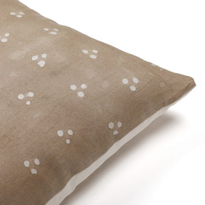 Close-up of Colin and Finn's Emberly Pillow Cover, showcasing the charming cluster of three dots forming a triangle pattern in rustic brown, hand-woven and block-printed for an authentic touch.