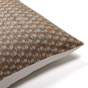 The corner of a brown pillow with white flowers - the Emery Pillow Cover from Colin + Finn 