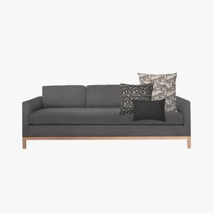 Ezra pillow combo with Magnolia, Felix, and Onyx Lumbar on a dark gray sofa