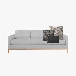 Ezra pillow combo with Magnolia, Felix, and Onyx Lumbar on a light gray sofa