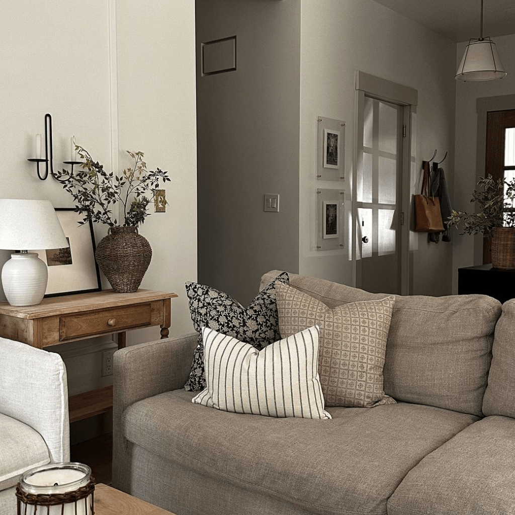 Felix, Georgia, and Winston Lumbar on a taupe couch in a living room. 
