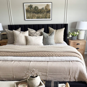 Multiple pillow covers from Colin and Finn on transitional home decor bed with black headboard.