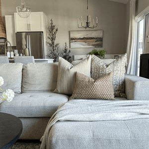 Isabelle, Darcy, and Emery Lumbar in the corner of a tan couch