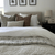 A bed with a gray headboard and Kennedy, Emery, and Jade Lumbar