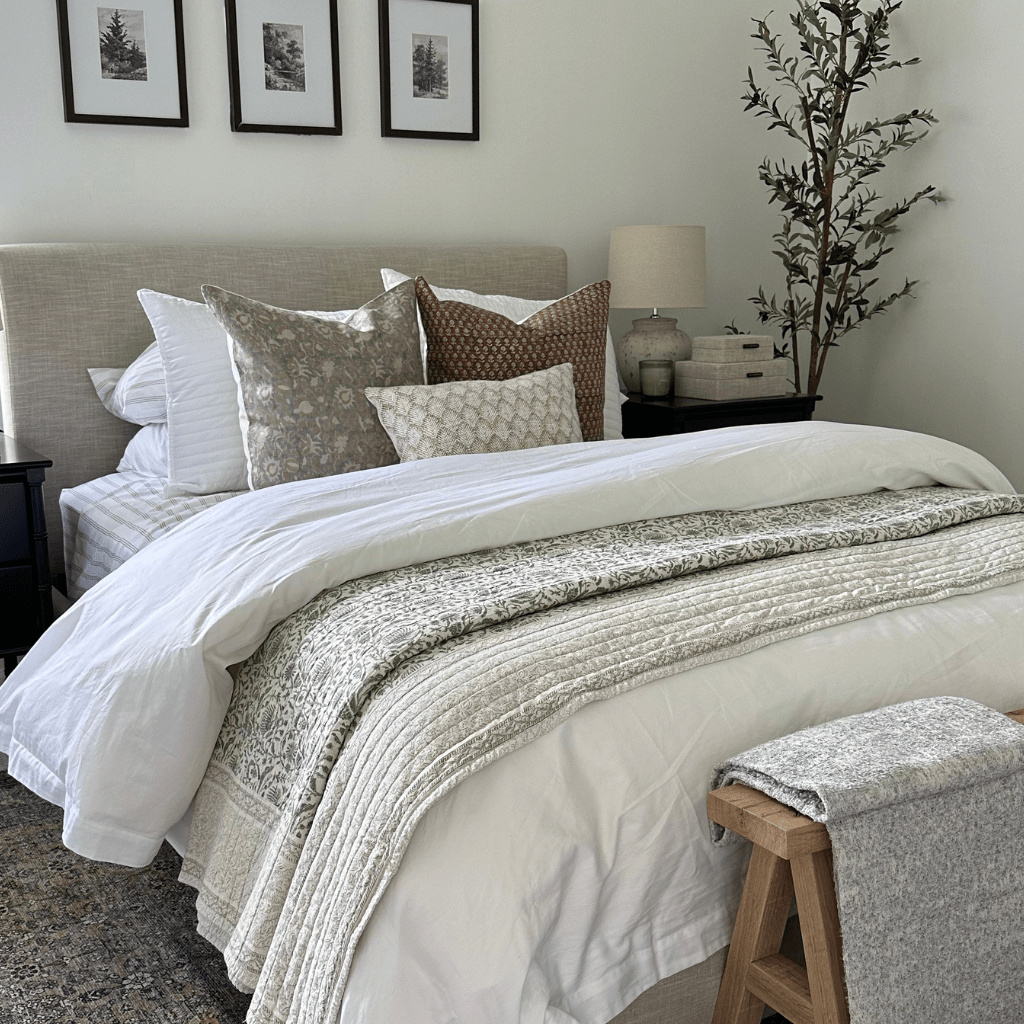A bed with a gray headboard and Kennedy, Emery, and Jade Lumbar from Colin + Finn