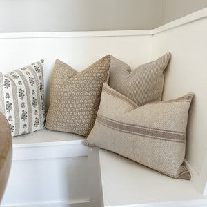 Leighton, Matilda, Laney, and Arizona lumbar pillow covers from Colin and Finn on a white bench.