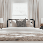 A closeup of Madison, Logan, and Rory pillows on a bed in front of a window