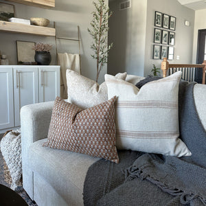 Arizona, Louise, and Emery lumbar pillow covers from Colin and Finn on gray sofa with gray blanket on sofa. 
