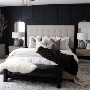 xA cream bed against a black wall with a dark brown blanket and Madison, Neville Mocha, Livvy, Karina, Jade, Logan, and Bardot Lumbar pillows