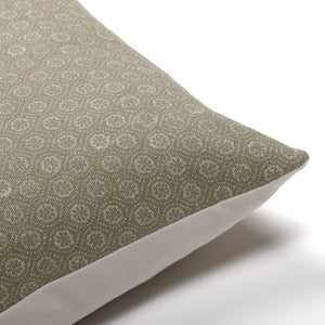 Upper corner of Matilda, an olive green pillow cover with white floral motif from Colin and Finn.