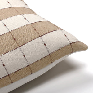 Upper corner view of the Prescott Lumbar pillow cover from Colin and Finn showing the taupe, ivory, and brown/rust various stripes.