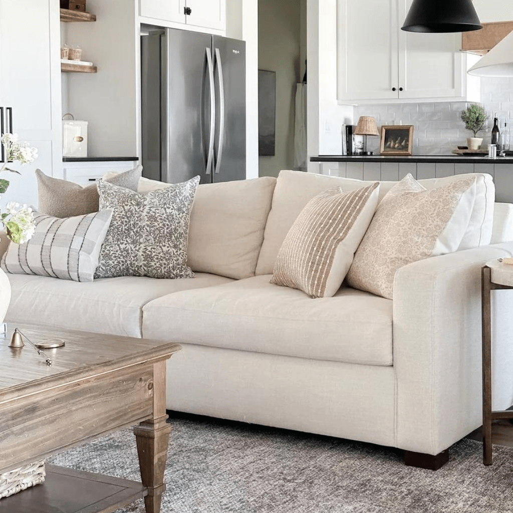 A cream couch with 5 Colin + Finn pillows - Royce Lumbar, Waylon, Penelope, Bardot, and Delilah