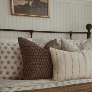 A closeup of Serena, Logan, and Rory Lumbar on a bed