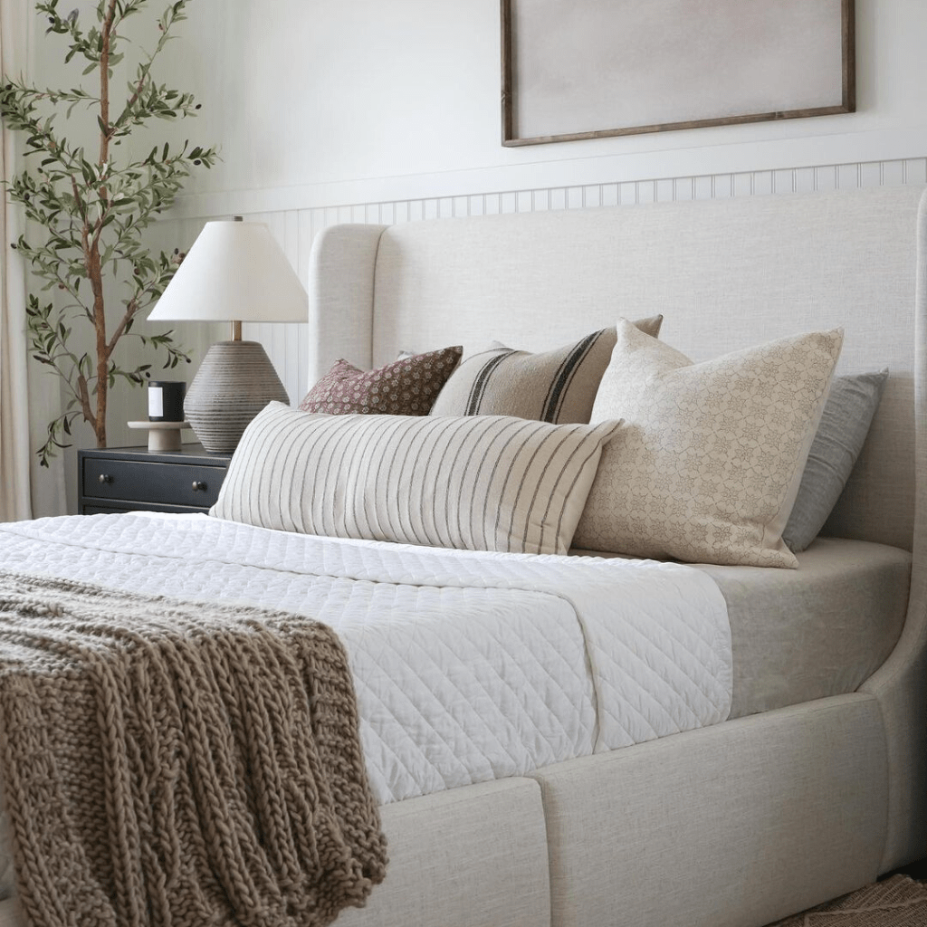 Various throw pillow covers from Colin and Finn on white bed.