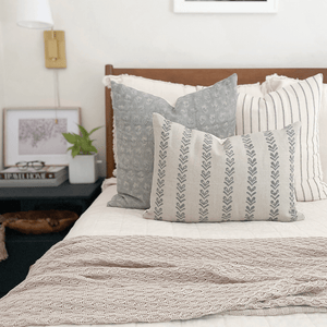 Ava pillow combination from Colin and Finn with Eloise, Winston, and Blaine lumbar on white bedding with wood headboard.