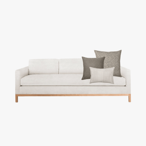 Cream couch with Bernard pillow combination on a white background.