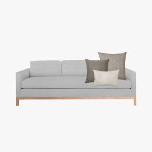 Bernard pillow combo on a light gray sofa with white background.