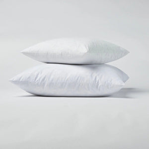 Feather down and down alternative Colin and Finn throw pillow inserts laying flat on a white background.