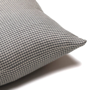 Corner view of the Caldwell pillow cover showing the small, blue gingham pattern on the front and back of the pillow cover.